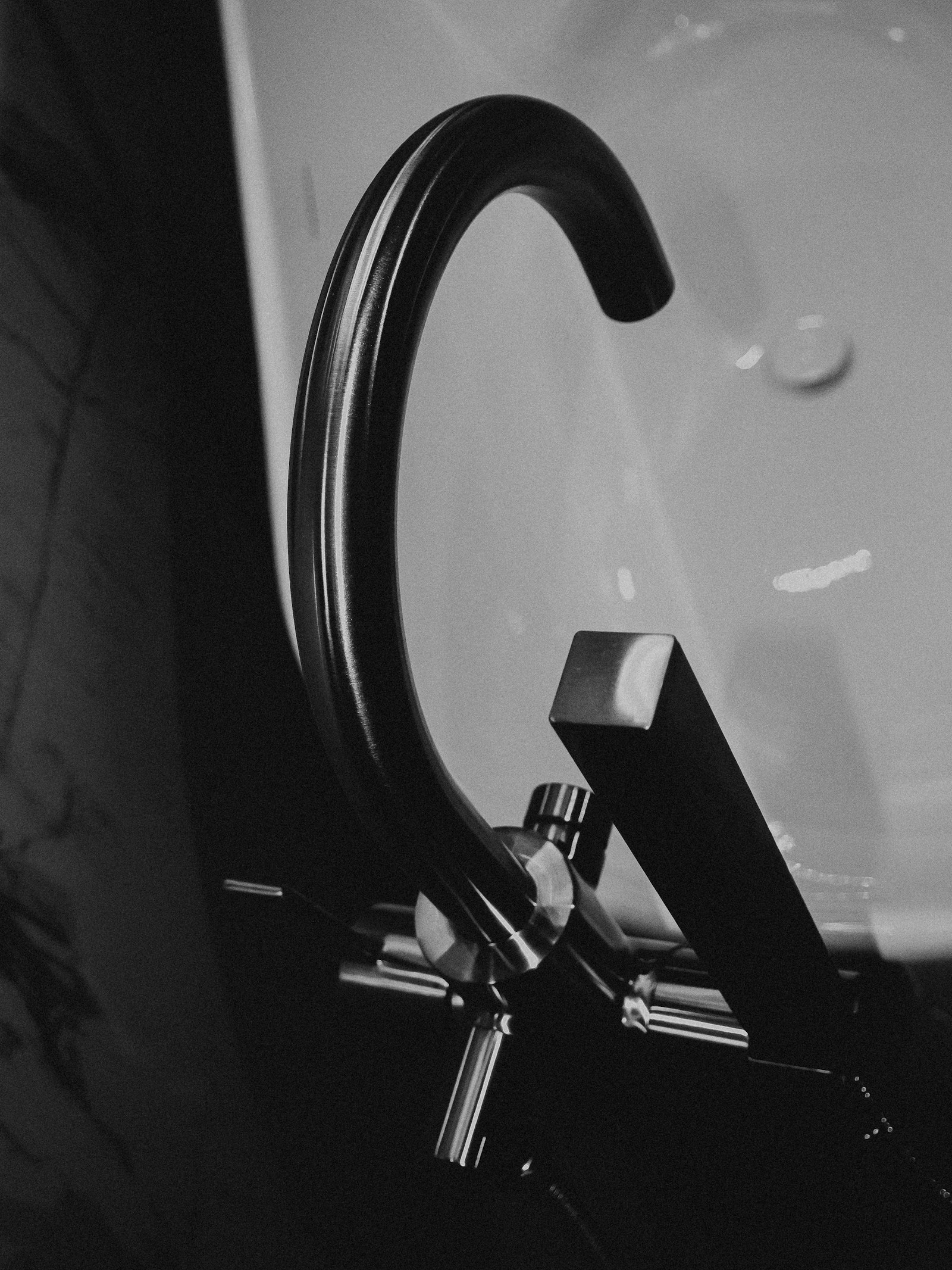Close view of a modern bathtub faucet and water controls